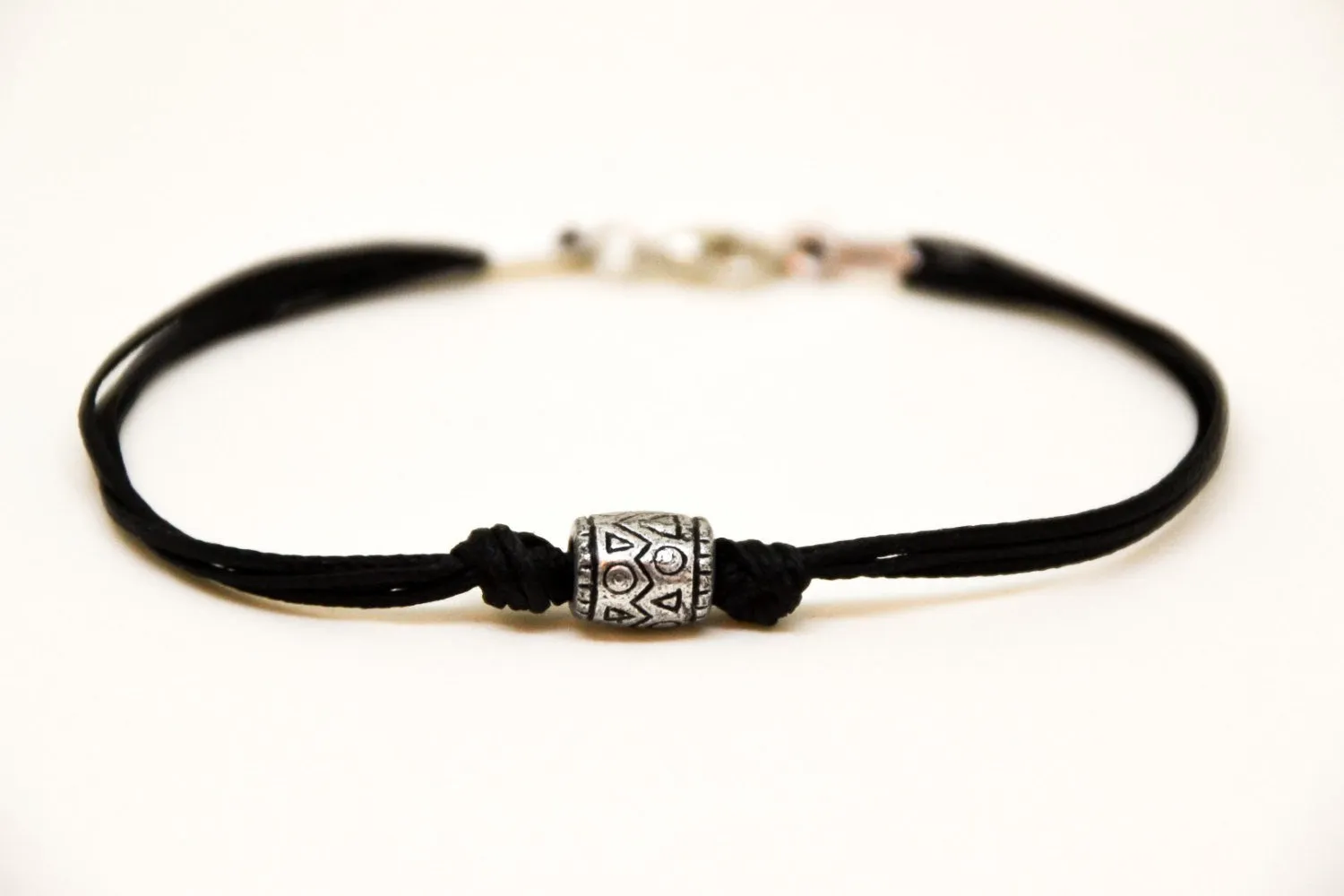 Men's bracelet with a silver aztec tribal bead and a black cord